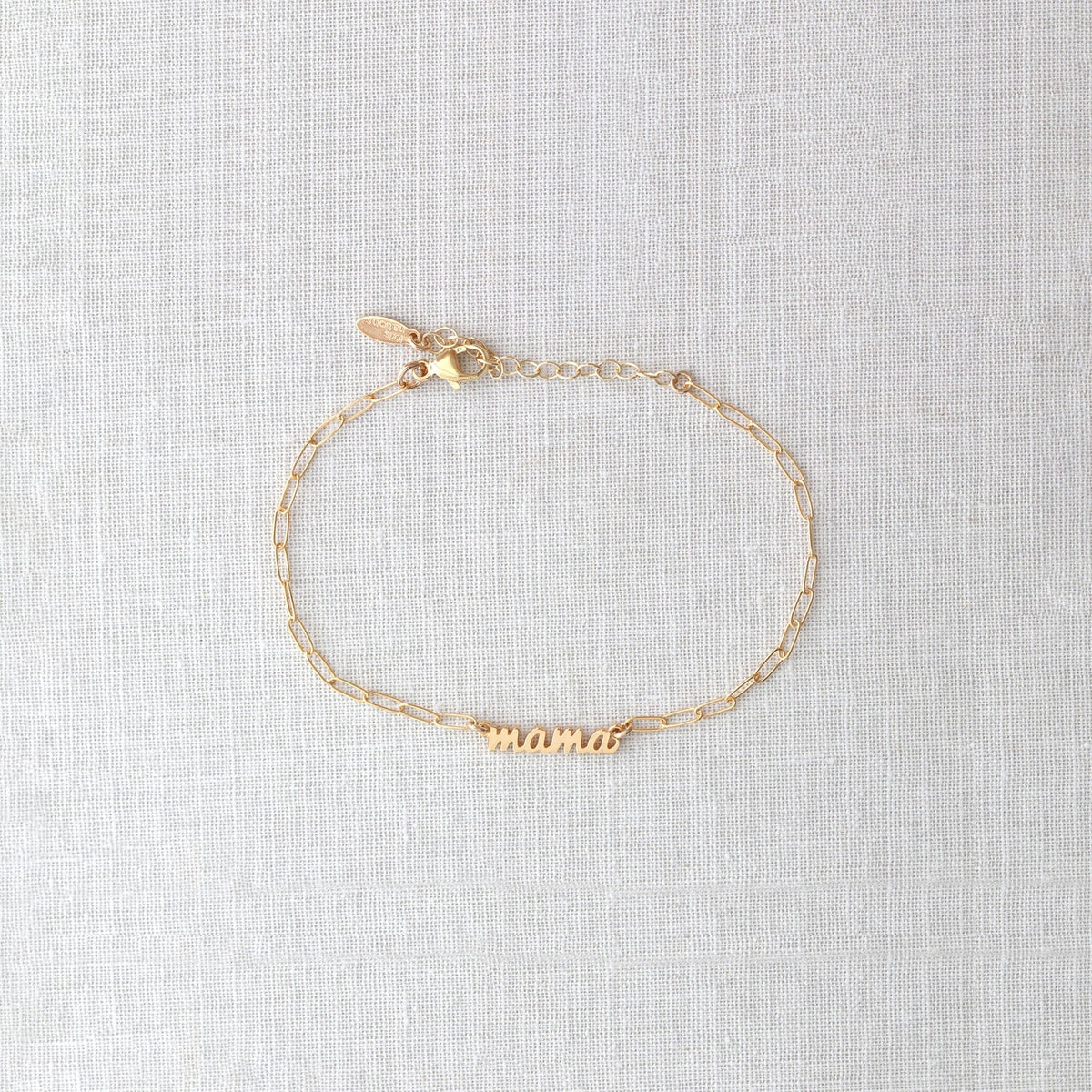 Gold Mama Bracelet with the word mama in script on a dainty chain