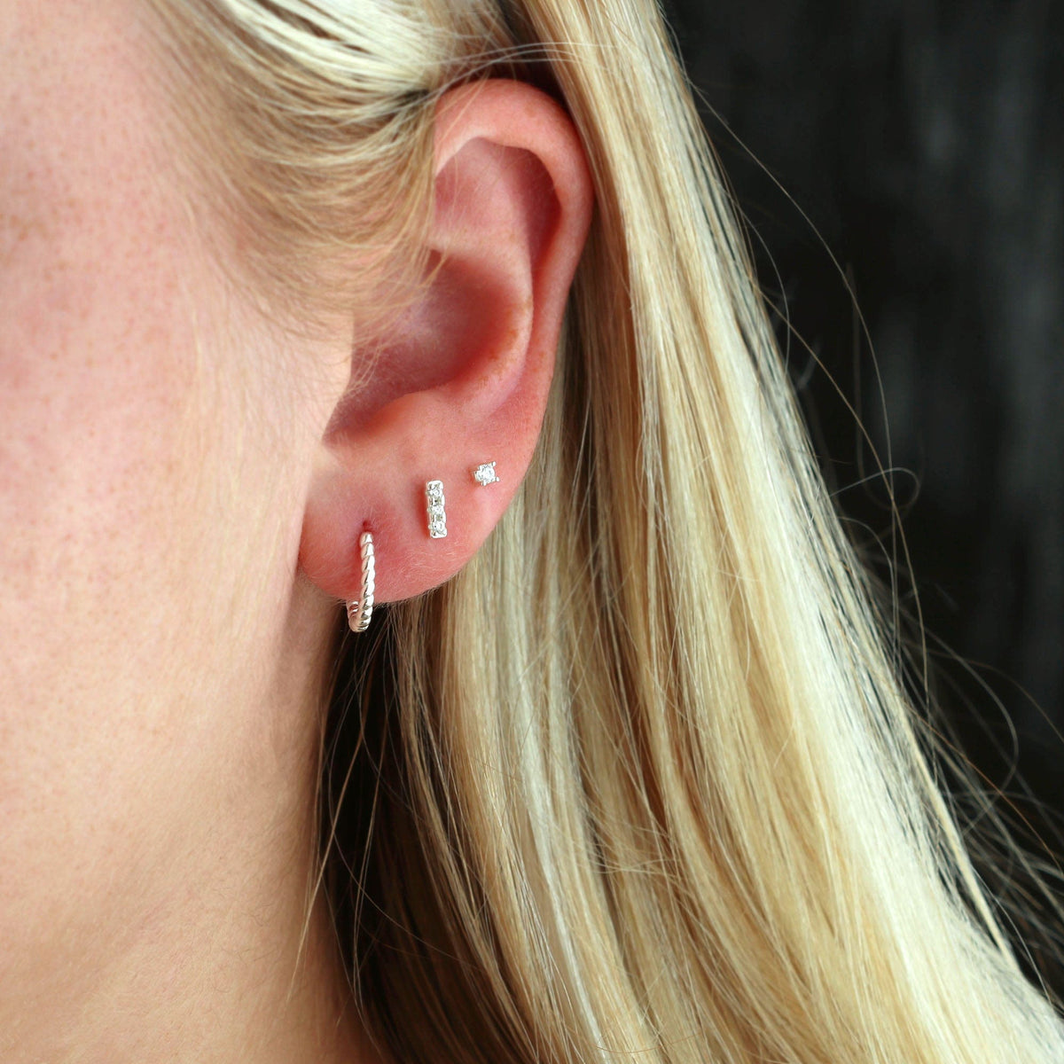 Sterling silver Bar Dash Crystal Stud worn in an ear stack with a silver huggie