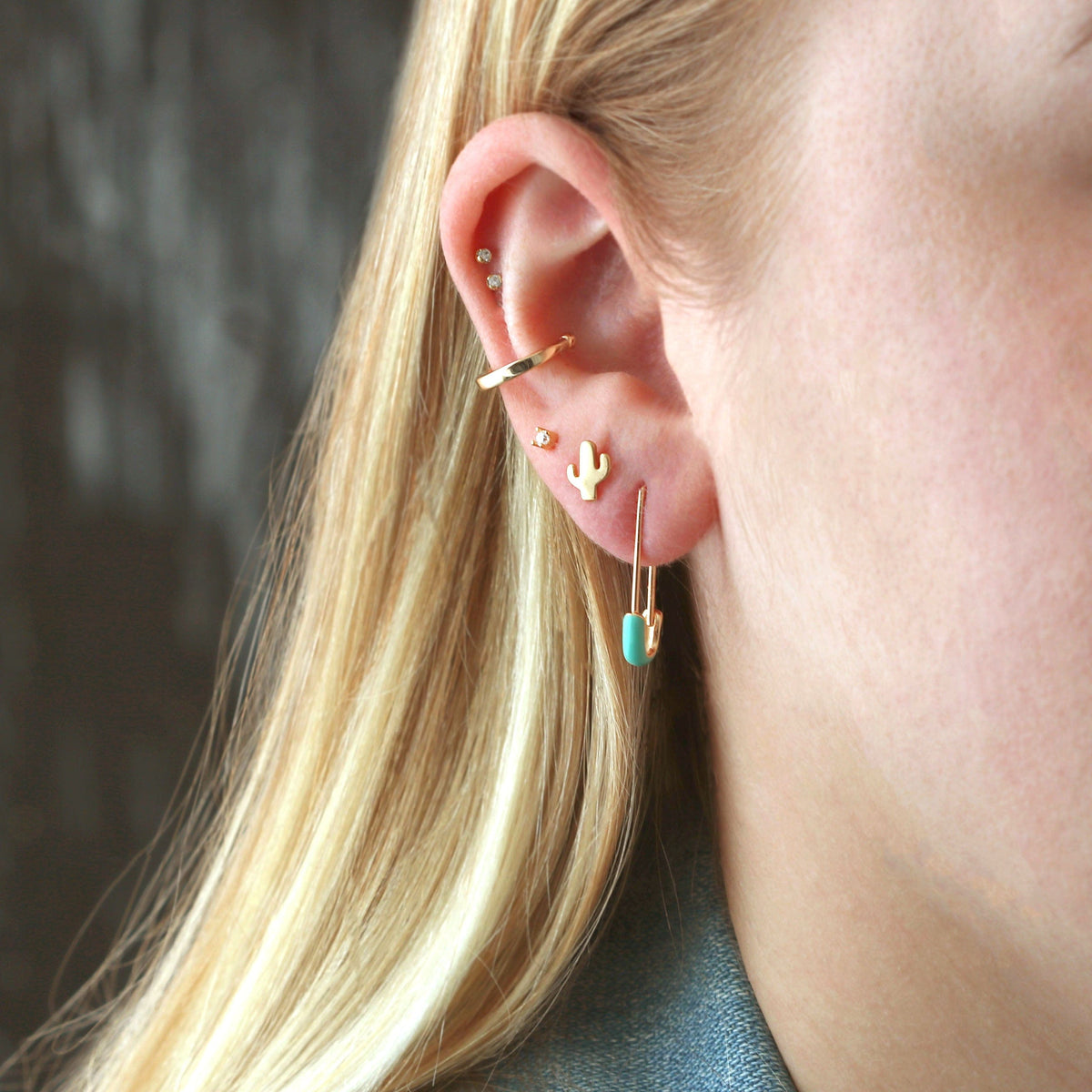 Gold Cactus Stud worn in an ear stack with an ear cuff and other gold earrings
