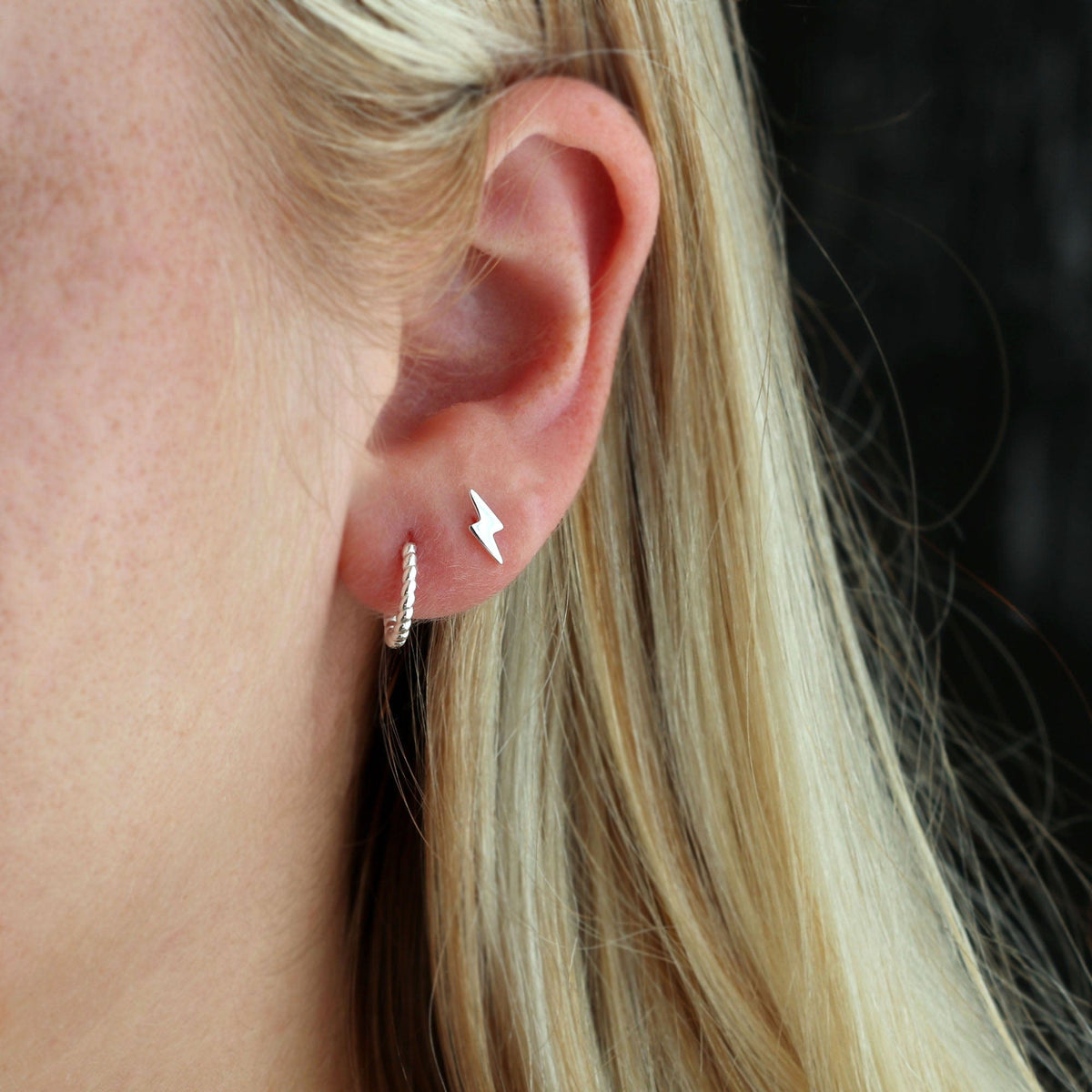 Sterling silver Lightning Bolt Stud worn in an ear stack with a silver huggie