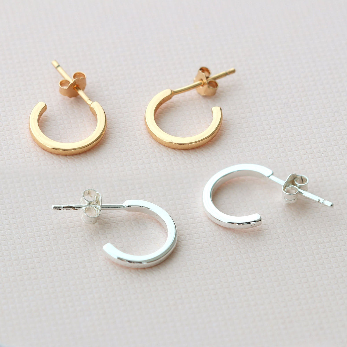 Classic huggie hoop earrings in 18K gold vermeil and sterling silver, shown side by side