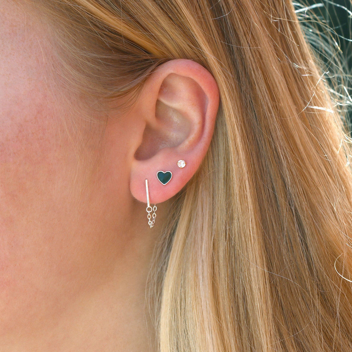 Black Petite Heart Enamel Stud worn in an ear stack with a silver chain earring