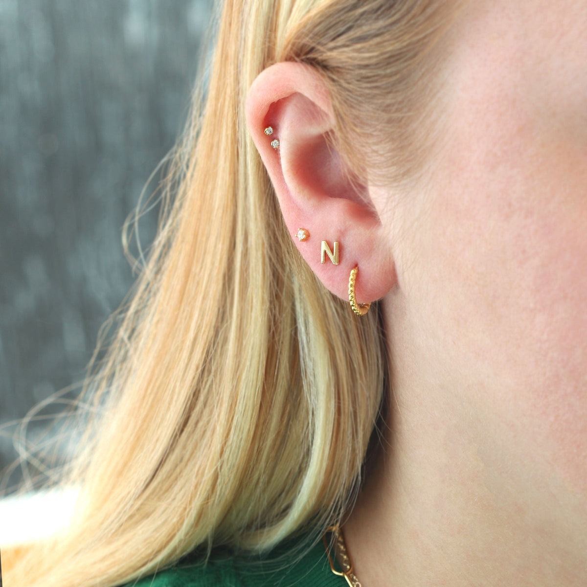 Gold Single Letter Stud worn with a gold huggie hoop