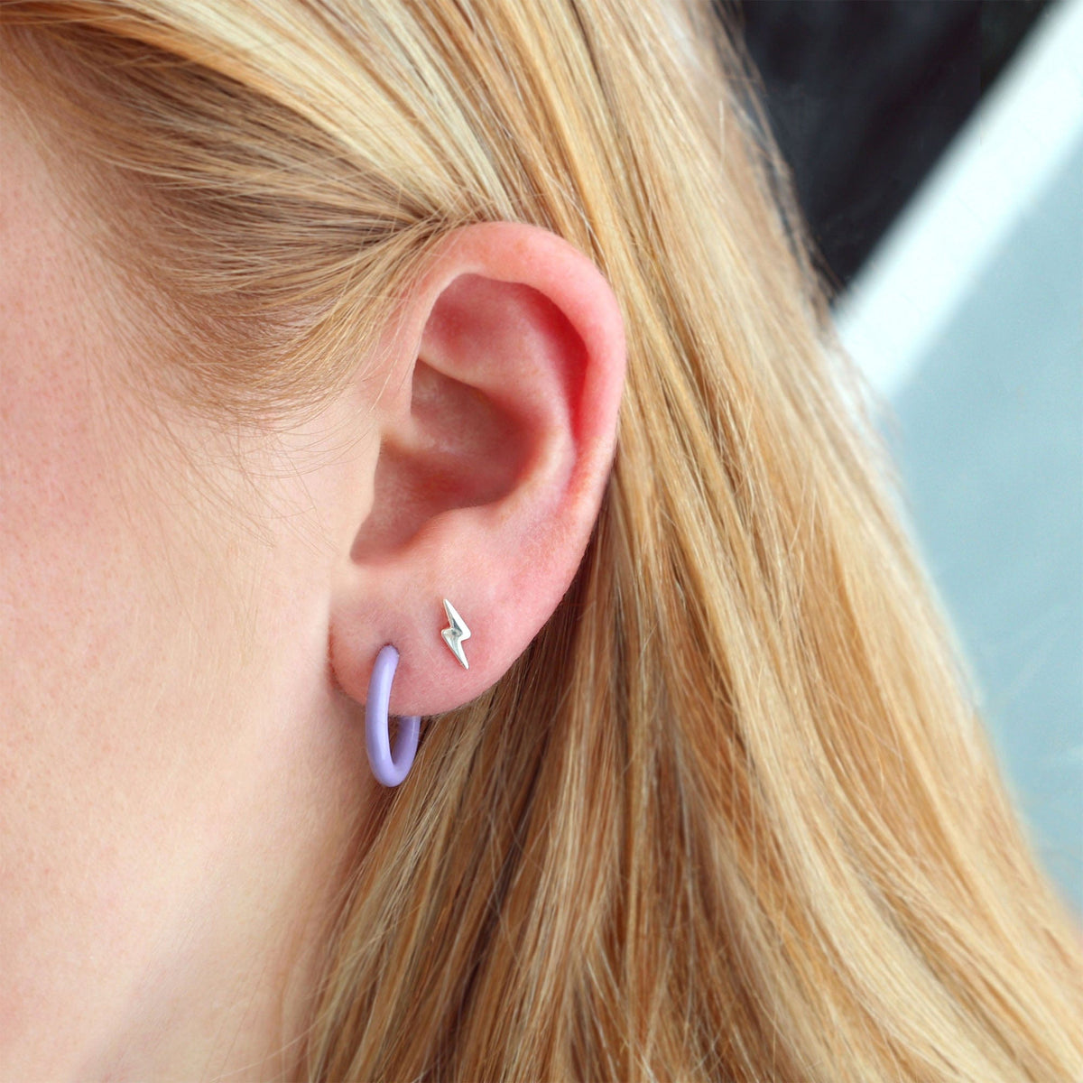 Lightning Bolt Stud worn with a periwinkle enamel huggie hoop