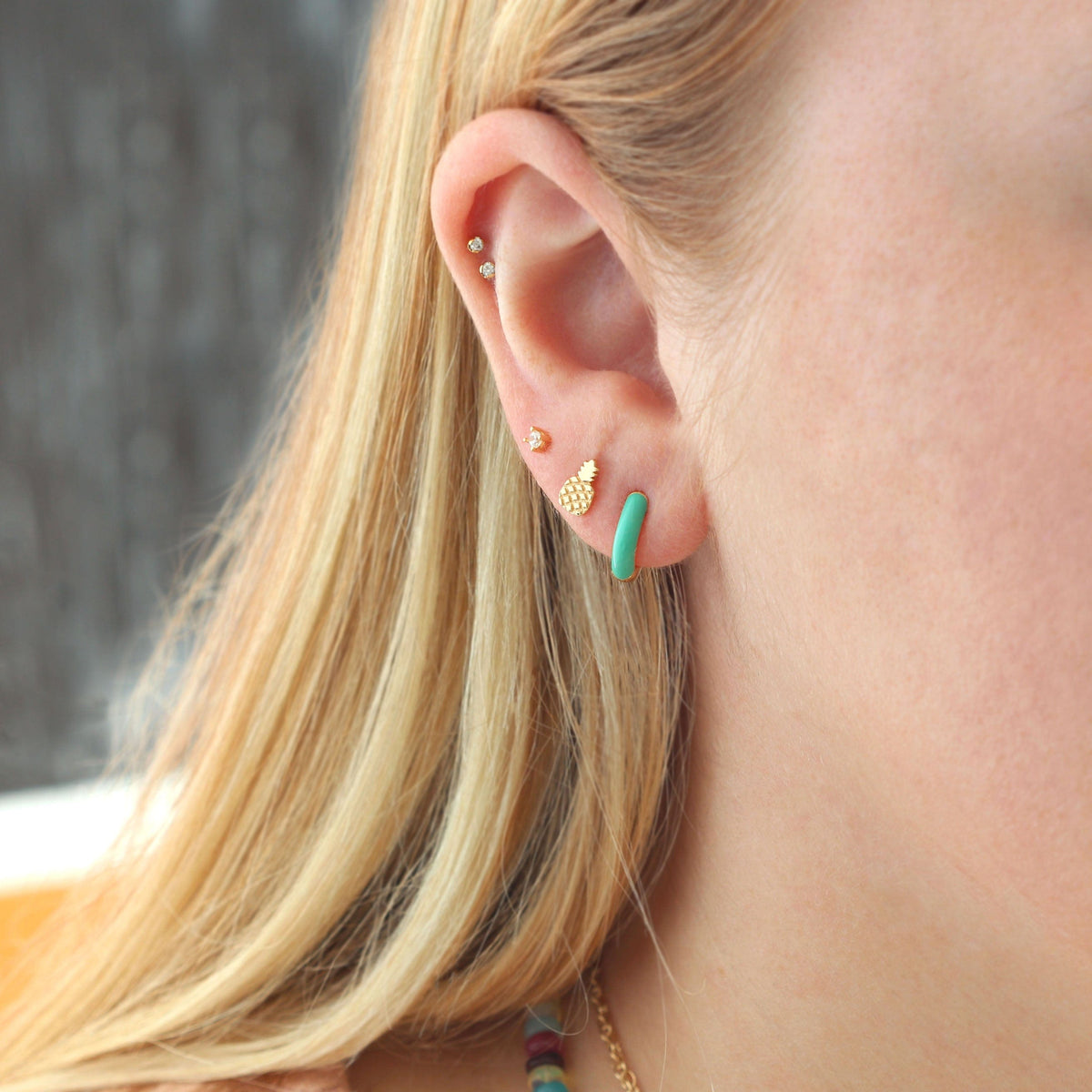 Gold Pineapple Stud worn in an ear stack with colorful enamel earrings
