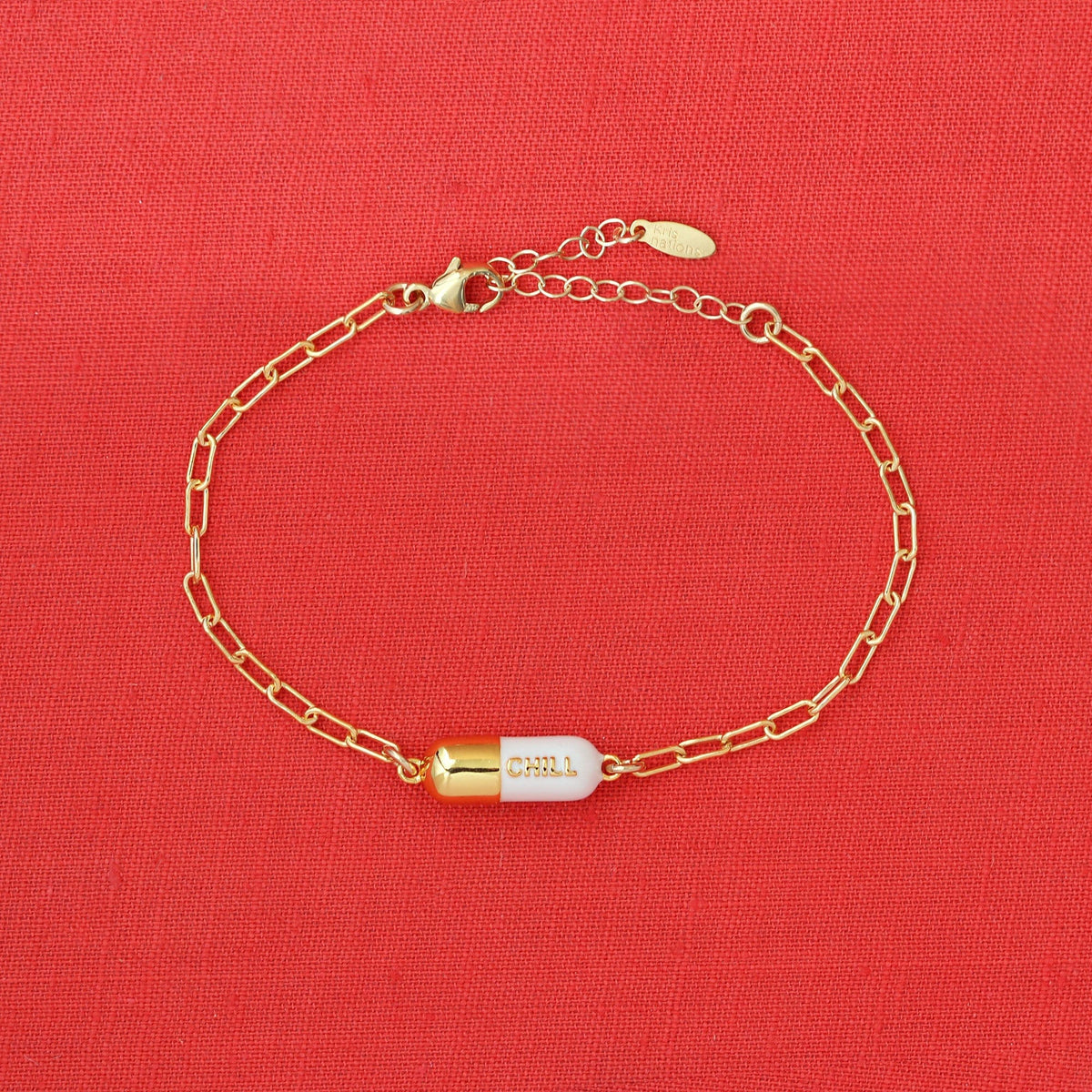White Chill Pill Bracelet on a red background