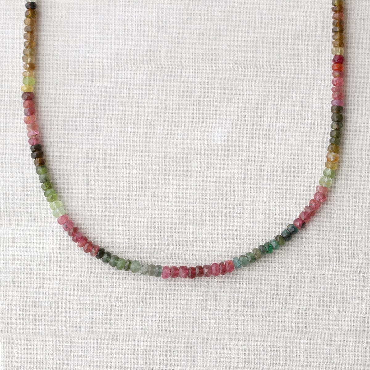 Watermelon Tourmaline Faceted Gemstone Beaded Necklace in pink and green on white linen