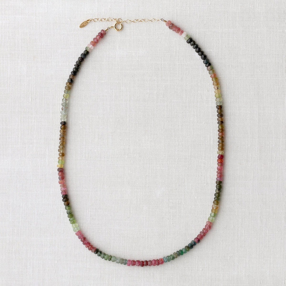 Watermelon Tourmaline Faceted Gemstone Beaded Necklace laid out to show the gold clasp