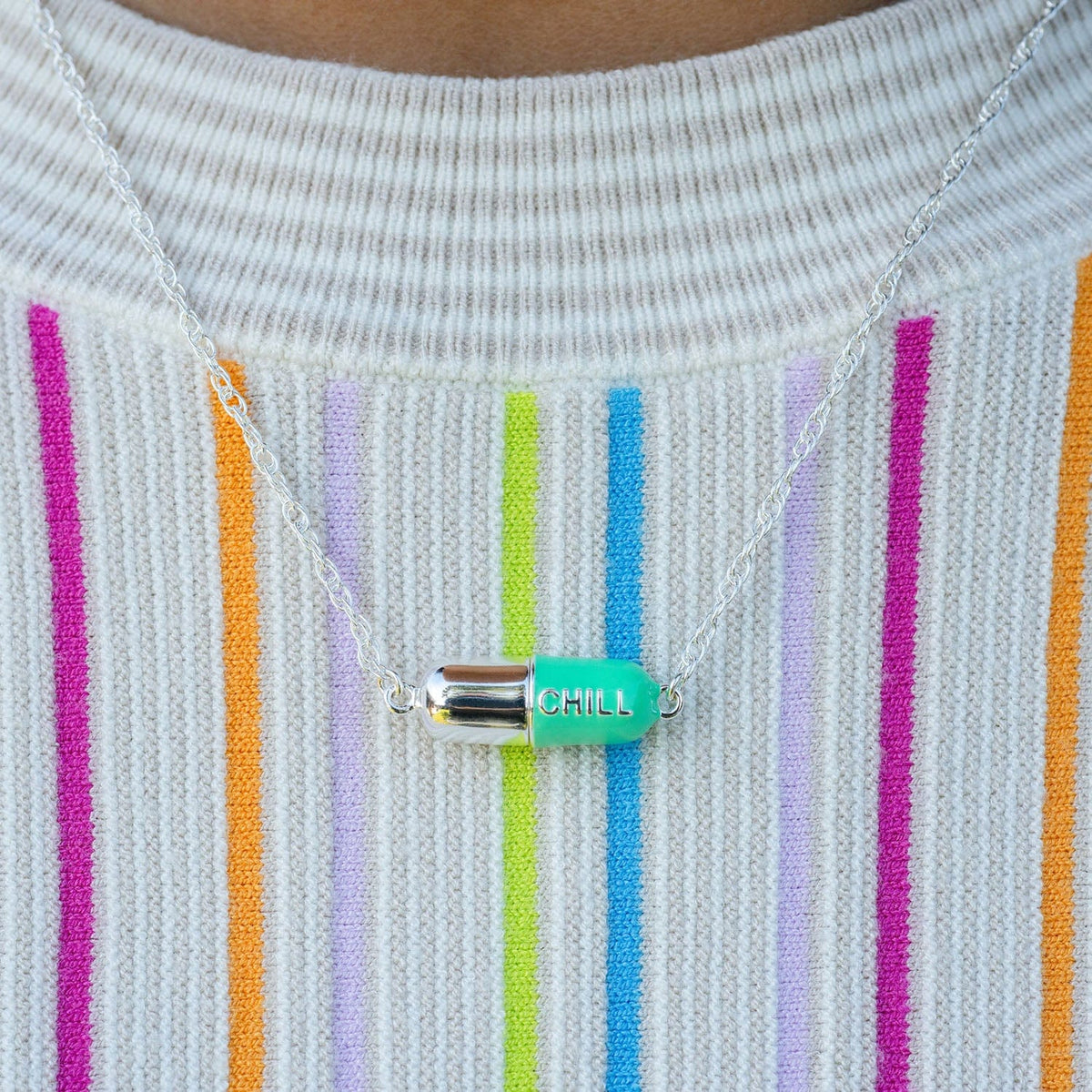 Turquoise Big Chill Pill Chain Necklace over a striped sweater