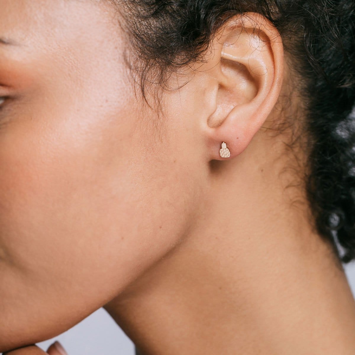 Close-up of an ear wearing a gold Pineapple Stud