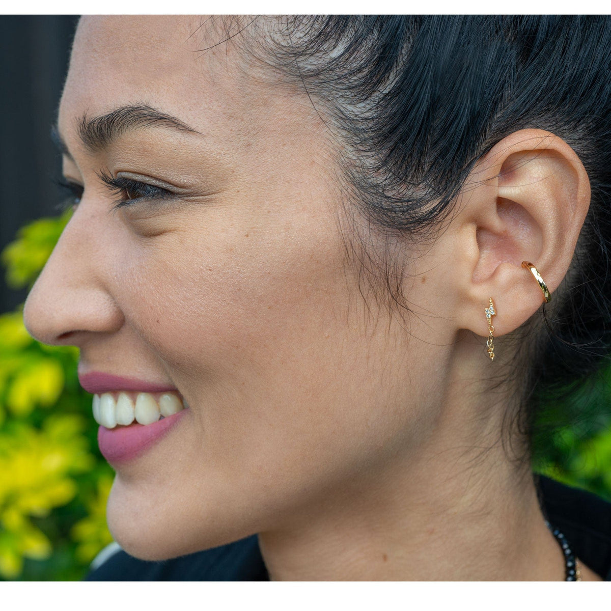 Smiling woman with dark hair pulled back wearing the Round Ear Cuff and gold studs