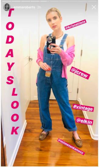 Emma Roberts in a pink cardigan and denim overalls wearing the Watermelon Tourmaline necklace in a mirror selfie